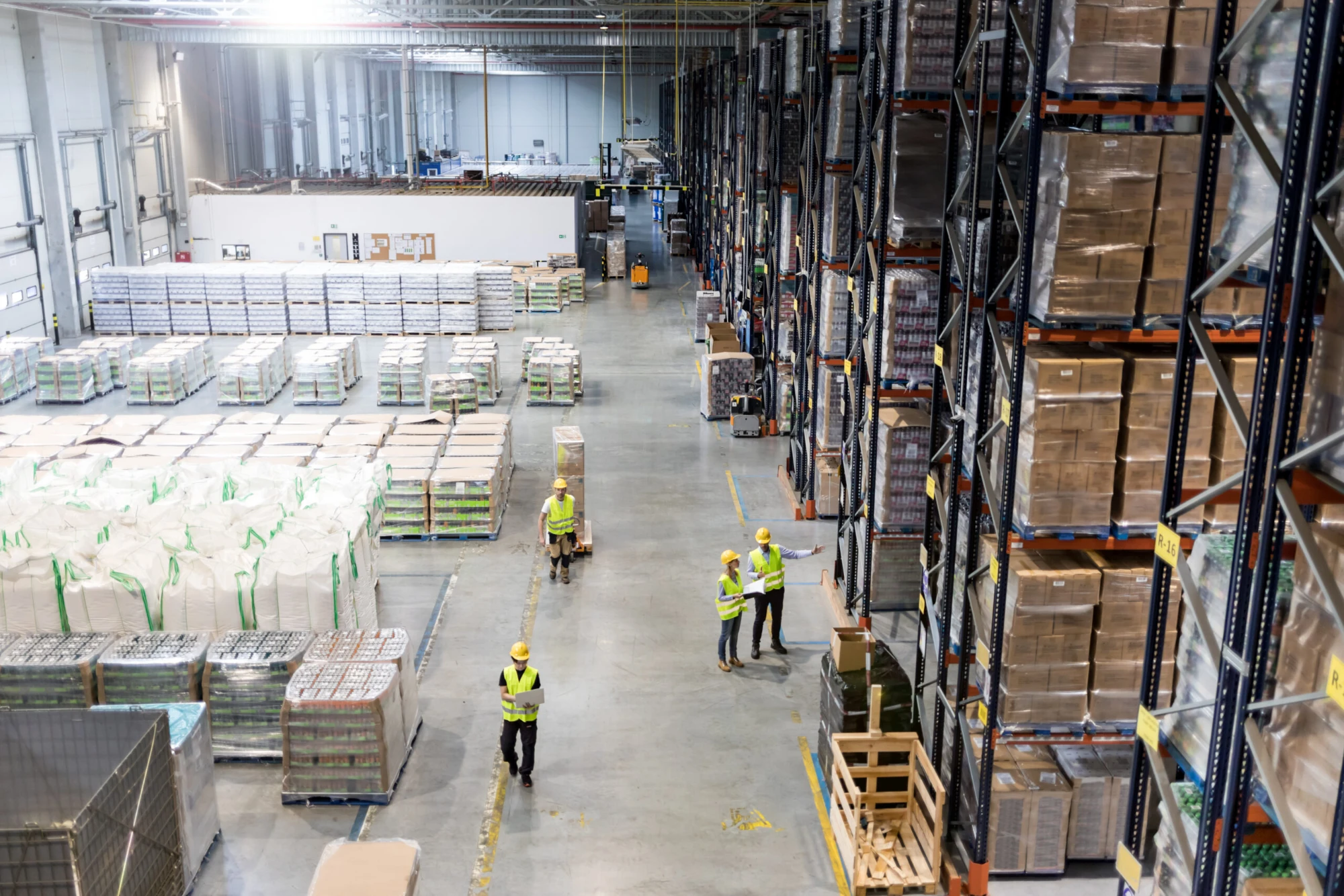 Warehouse workers operating forklifts, viewed from above