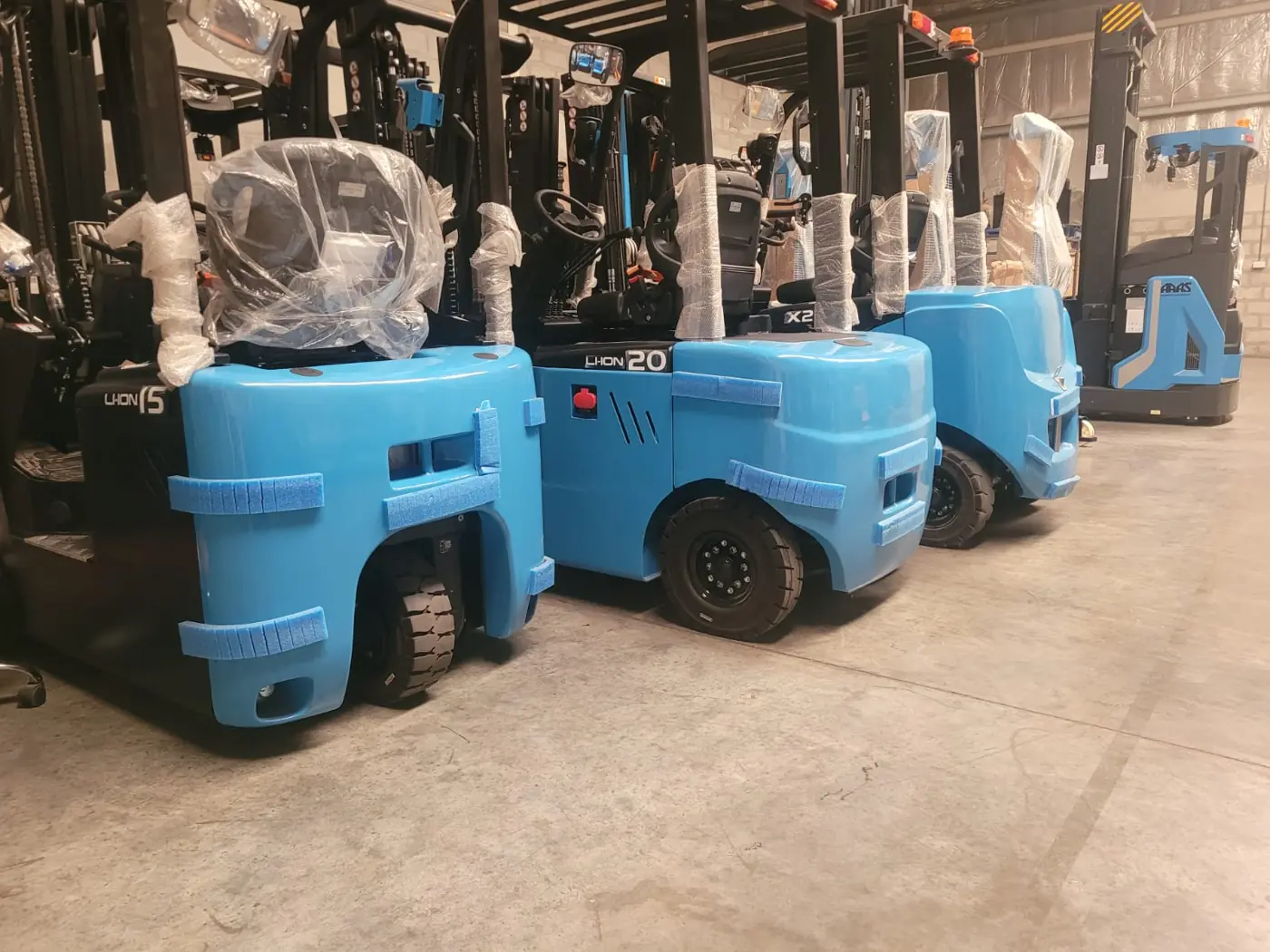 New electric forklifts in the ARAS warehouse, Jebel Ali Free Zone Dubai, factory wrapping still on